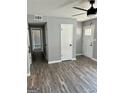 A well-lit living room showcasing modern gray wood flooring, light gray walls, and white doors at 23 Hampton Locust Grove Rd, Hampton, GA 30228