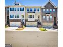 Attractive townhome exterior with brick accents, garages, and well-maintained landscaping at 429 Stagecoach Bnd, Smyrna, GA 30080
