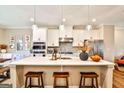 Beautiful kitchen boasts a spacious island, stainless appliances, white cabinets, and pendant lighting at 429 Stagecoach Bnd, Smyrna, GA 30080