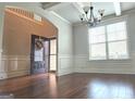Elegant foyer with hardwood floors, large window and a front door with a floral wreath at 207 Birchwood Dr, Loganville, GA 30052