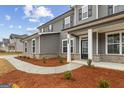A charming gray two-story home with manicured front yard and welcoming entrance at 275 Arwen Dr # 68, Mcdonough, GA 30252