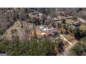 Aerial shot showcases the private backyard, pool, and basketball court amenities surrounded by trees at 1408 Hemphill Rd, Stockbridge, GA 30281