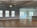 Spacious living room with a ceiling fan, wood floors, and plenty of natural light at 5311 Tuscany Dr # 98 Plapprox Sqft, Douglasville, GA 30135