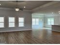Spacious living room with a ceiling fan, wood floors, and plenty of natural light at 5311 Tuscany Dr # 98 Plapprox Sqft, Douglasville, GA 30135