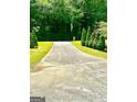 Long concrete driveway leading to the home at 2555 Rockbridge Nw Rd, Conyers, GA 30012