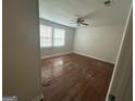 Bedroom featuring hardwood floors, neutral walls, and windows allowing natural light at 1721 Lisbon Sw Dr, Atlanta, GA 30310