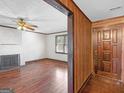 Inviting living room featuring hardwood floors, a fireplace, and an entry door plus a window to let the light in at 1713 Bramlett Shoals Rd, Lawrenceville, GA 30045