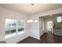 Dining room with hardwood floors, wainscotting and decorative chandelier at 4853 Walkers Green, Mableton, GA 30126