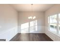 Sun-drenched dining room with hardwood floors and wainscotting details at 4853 Walkers Green, Mableton, GA 30126
