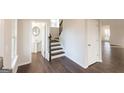 Bright foyer features wood floors, stairs to the second floor, and entry to the half bath at 4853 Walkers Green, Mableton, GA 30126