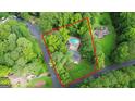 Aerial view of a property showing its layout, pool, and surrounding greenery at 105 Oak Leaf Ct, Fayetteville, GA 30214