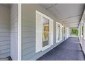 Covered front porch featuring white columns and charming outdoor lighting at 105 Oak Leaf Ct, Fayetteville, GA 30214