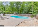 Backyard featuring a refreshing in-ground pool and surrounding patio space at 105 Oak Leaf Ct, Fayetteville, GA 30214