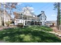 Gorgeous backyard featuring a covered patio, and lush lawn, perfect for outdoor living and entertaining at 4185 Etcetera Ln, Cumming, GA 30041