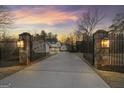 Gated driveway leading to a beautiful, newly-built home with an inviting entrance at 4185 Etcetera Ln, Cumming, GA 30041