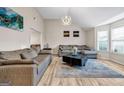 Bright living room featuring two sofas, a modern light fixture, and large windows at 4439 Persian Ct, Snellville, GA 30039