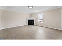 Spacious living room featuring wood floors, a fireplace, and a light fixture at 309 Coral Cir, Mcdonough, GA 30253