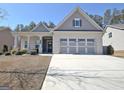 Charming exterior of this house, featuring a three-car garage and a cozy covered front porch at 625 Timberbrook Dr, Sharpsburg, GA 30277