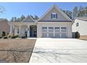 Charming single-story home featuring a three-car garage and an inviting covered front porch at 625 Timberbrook Dr, Sharpsburg, GA 30277