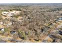 An aerial view showing the surrounding neighborhood and treeline with a school at 6198 Rocky Creek Dr, Douglasville, GA 30135