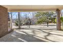 View from the carport to the street showcasing a lovely treed lot at 6198 Rocky Creek Dr, Douglasville, GA 30135