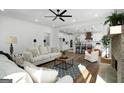 Spacious open-concept living room with hardwood floors, brick fireplace, and seamless flow to the kitchen at 5167 Martin St, Covington, GA 30014