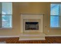 Cozy fireplace featuring a marble hearth, decorative mantel, and natural light from bright windows at 1186 Diamond Xing, Mcdonough, GA 30252