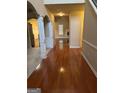 Inviting foyer featuring gleaming hardwood floors, decorative columns, and neutral paint tones at 1186 Diamond Xing, Mcdonough, GA 30252