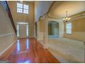 Grand foyer with high ceilings, hardwood floors, staircase and elegant chandelier, perfect for welcoming guests at 1186 Diamond Xing, Mcdonough, GA 30252