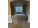 Cozy living room with neutral carpet, large window with blind, and traditional wainscoting details at 1186 Diamond Xing, Mcdonough, GA 30252