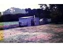 A small outbuilding is shown with a traditional shed structure and adjacent fenced areas at 2171 Highway 42 N, Mcdonough, GA 30253