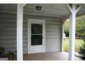 Inviting covered porch with supporting columns and an exterior door at 2171 Highway 42 S, Mcdonough, GA 30253