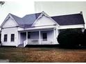 Charming vintage home featuring a welcoming front porch, surrounded by a lush lawn at 2171 Highway 42 S, Mcdonough, GA 30253