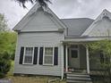 Charming home featuring classic architecture with black shuttered windows and cozy front porch at 2171 Highway 42 S, Mcdonough, GA 30253