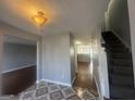 Inviting entryway featuring decorative tile flooring, stairs to the upper level, and access to the kitchen at 10988 Mansura Pl, Hampton, GA 30228