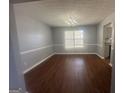 Dining room features wood-look floors, chair rail, and an elegant chandelier at 10988 Mansura Pl, Hampton, GA 30228