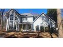 Charming two-story traditional home with a well-manicured lawn and inviting front porch seating at 300 Legacy Ln, Peachtree City, GA 30269