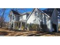 Traditional home with an attached garage, well-maintained lawn, and welcoming front porch with seating at 300 Legacy Ln, Peachtree City, GA 30269