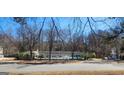 Community pool area featuring a pool house, and a pool with lounge chairs at 300 Legacy Ln, Peachtree City, GA 30269