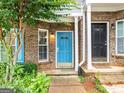 Close-up of two townhome entrances, one with a bright blue door and the other with a black door at 2523 Walden Lake Dr, Decatur, GA 30035