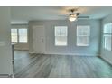 Bright living room featuring multiple windows and neutral gray-toned flooring at 425 Camella Cir # 90, Mcdonough, GA 30252