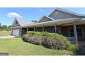 Beautiful home with brick facade, covered porch, and attached garage at 195 Twin Oaks Dr, Hampton, GA 30228