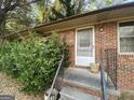 Exterior front entrance showcases a brick facade and metal railing at 439 Oakside Sw Dr, Atlanta, GA 30331