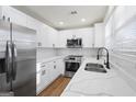 Modern kitchen featuring stainless steel appliances, white cabinets, and elegant countertops at 9317 Thomas Rd, Jonesboro, GA 30238