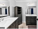 Elegant bathroom with double vanity, marble countertops, and a spacious storage unit at 203 Everhill, Peachtree City, GA 30269