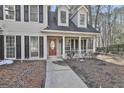 Charming home boasts a welcoming front porch with classic columns and black shutters at 114 Oak Ridge Dr, Sharpsburg, GA 30277