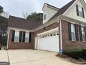Brick home with a 2 car garage and black shutters at 3223 Thornecreek Dr, Douglasville, GA 30135