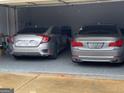Garage featuring cars and painted flooring at 3223 Thornecreek Dr, Douglasville, GA 30135