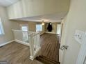 View from the stairs to the spacious living room with hardwood floors and a fireplace at 2270 Titan Ridge Dr, Decatur, GA 30035