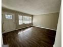 Bright living room with hardwood floors, a large window and a white front door at 2804 Mitchell Dr, Decatur, GA 30032